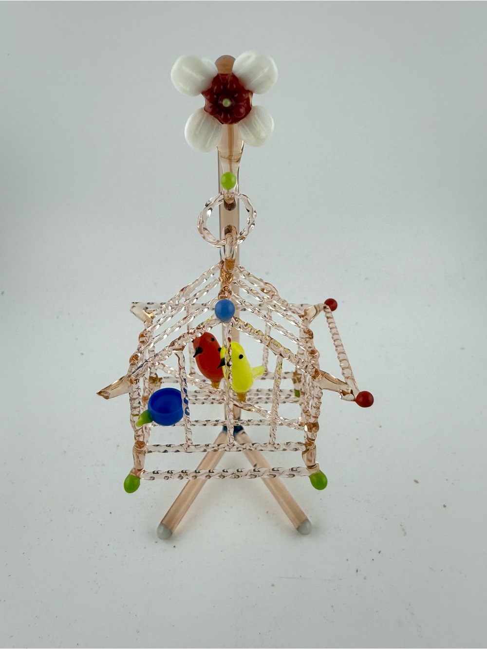 Hand-blown art glass birdcage figurine.